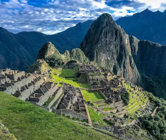 Explore the stunning ancient ruins of Machu Picchu, a UNESCO World Heritage Site in Peru, surrounded by majestic mountains.