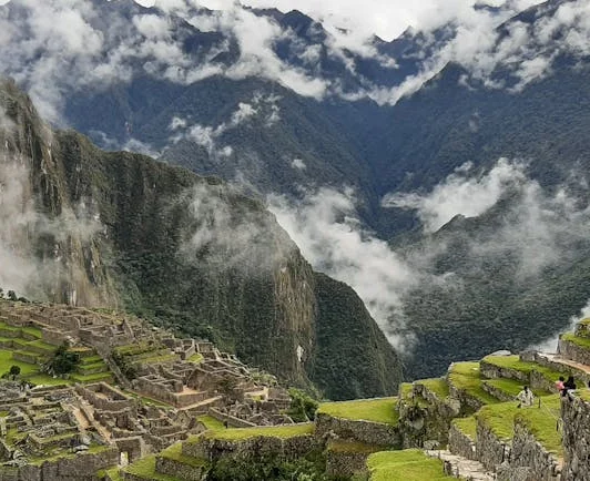 Breathtaking aerial view of the ancient Machu Picchu ruins in Cusco, Peru with lush mountain scenery.