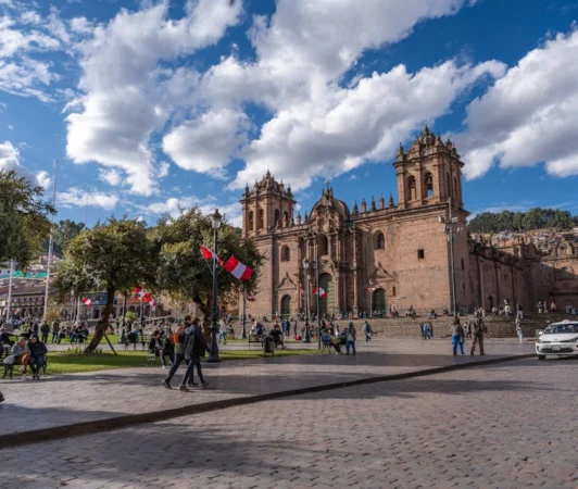 A lively day at Cusco's Plaza de Armas with the historic Cathedral and people enjoying the atmosphere.