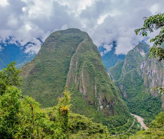 Breathtaking view of Putucusi mountain surrounded by lush greenery in Cusco, Peru.