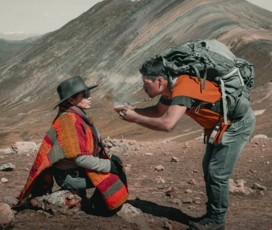 Captivating moment between hikers in traditional wear in the Andes mountains of Peru.